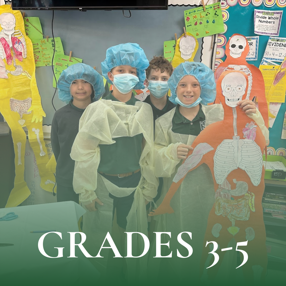 Elementary aged students dressed up in hospital gowns, blue caps, and face masks, holding up an outline of a skeleton