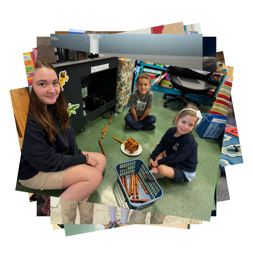 Students sit on floor with Lincoln Log house