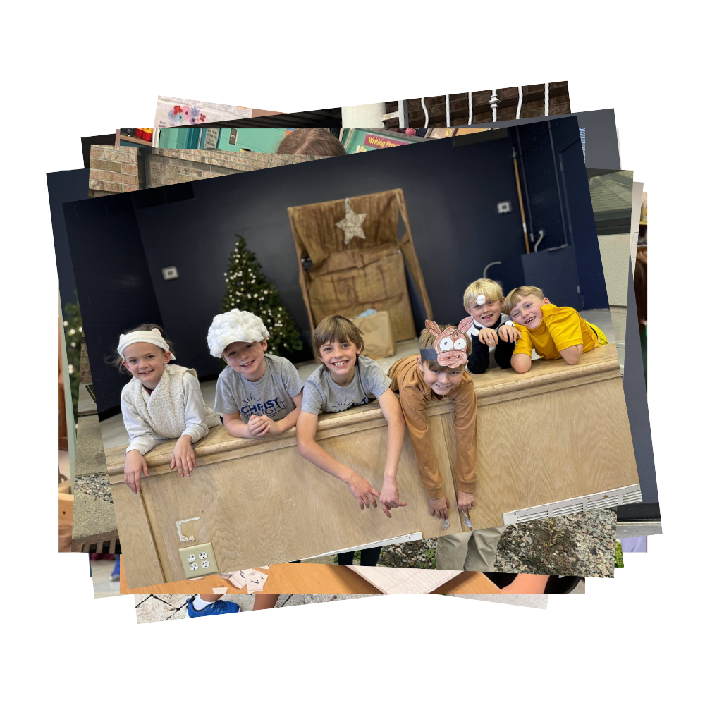 Students participating in Christmas pageant laying on the stage with scenery behind them