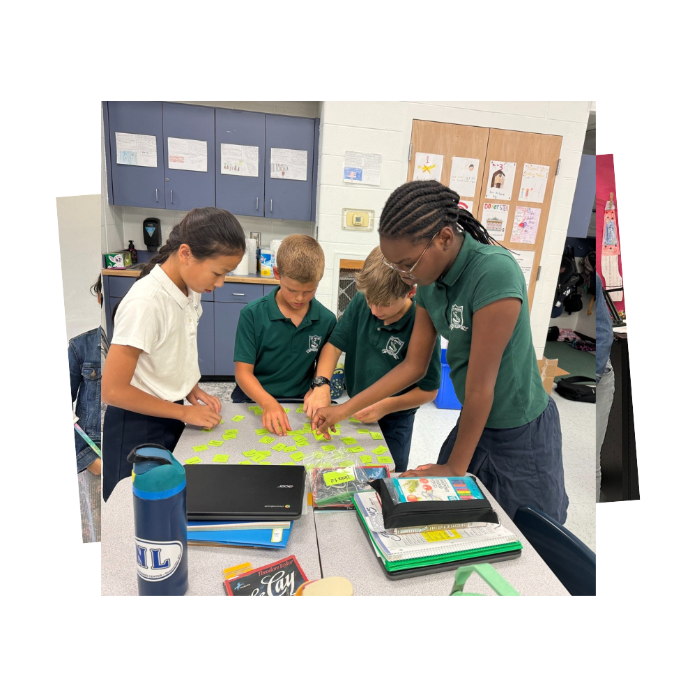 Four students working at table with green notes with vocabulary words on them