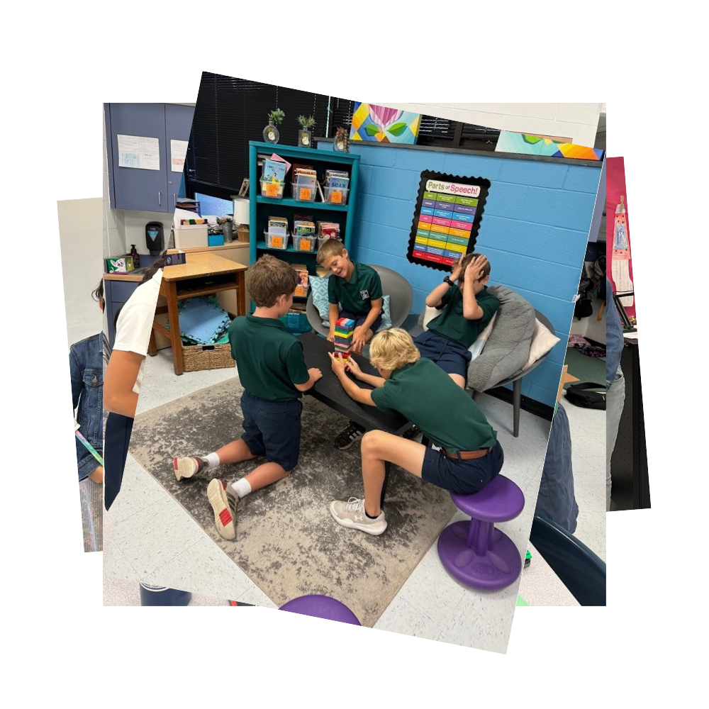 Four boys sitting in classroom playing Jenga
