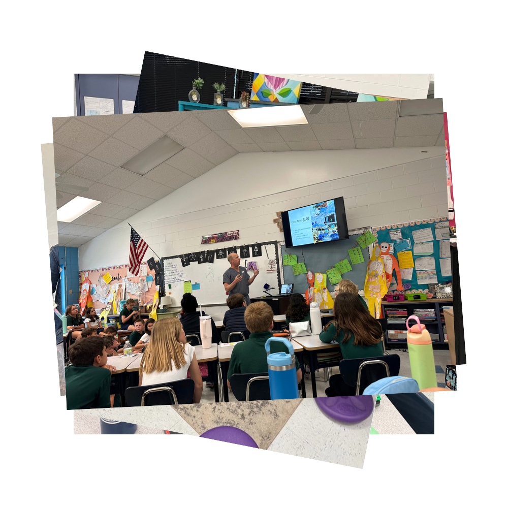 Doctor presenting to students sitting at tables looking at TV screen
