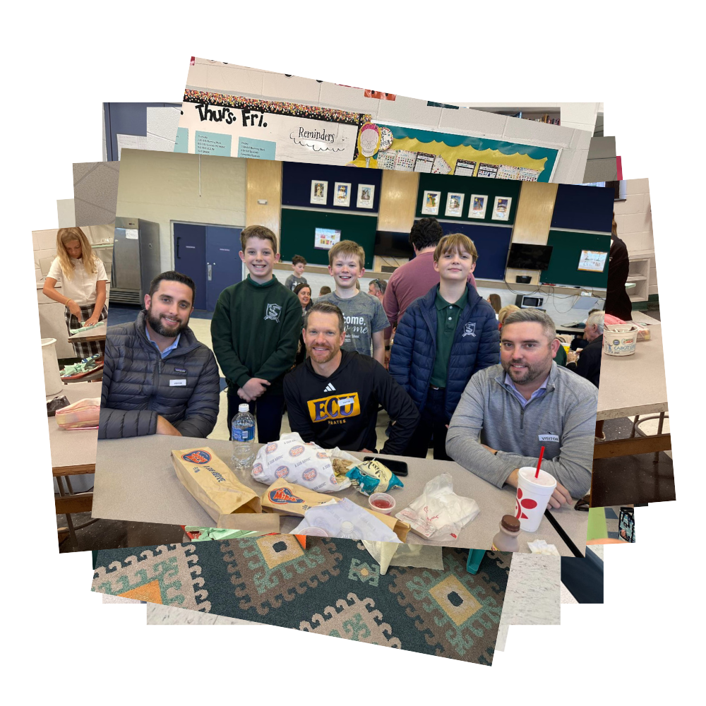Three boys standing behind three dads at school lunch