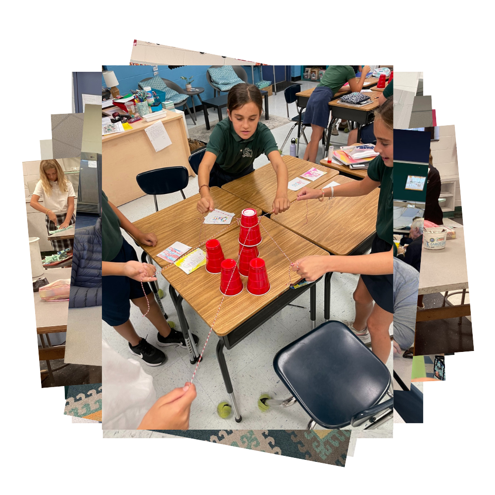 Students hold strings attached to red plastic cups stacked on a table