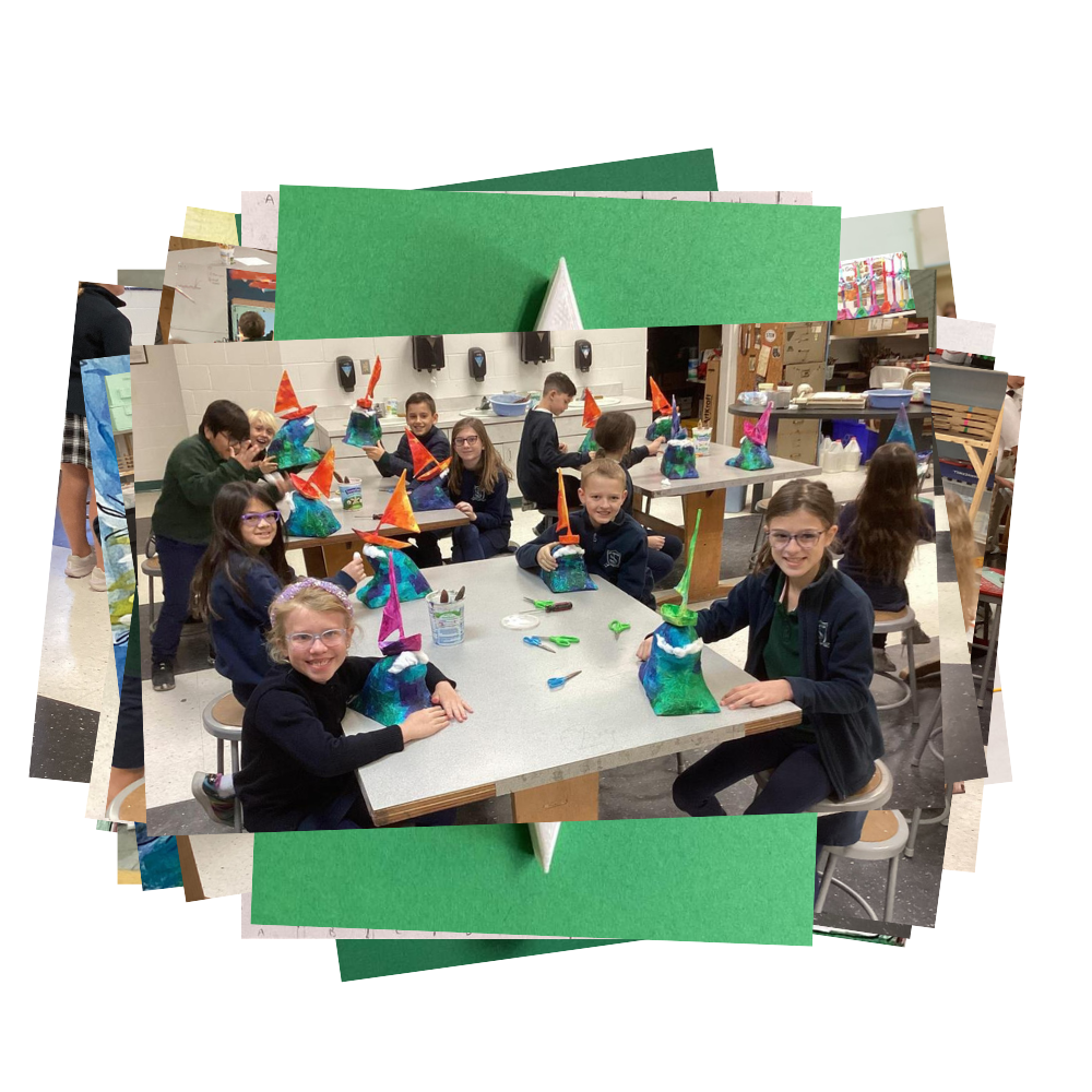 Students with painted sailboat sculptures in art class