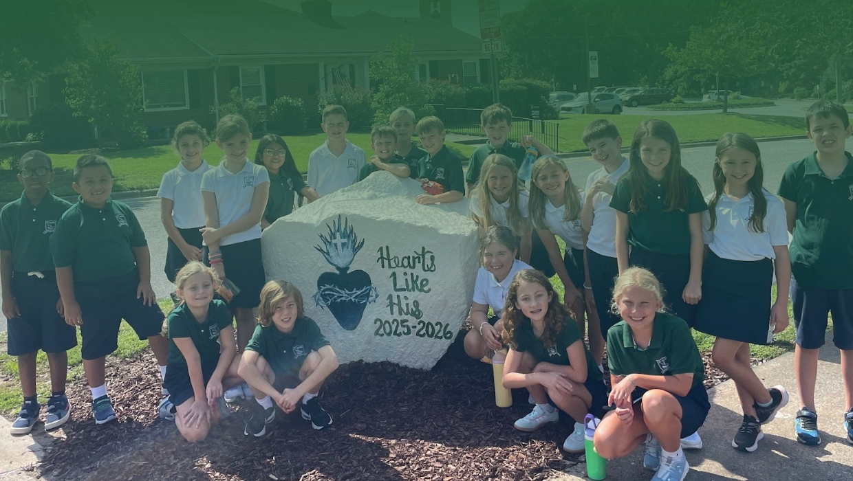 St. Peter Catholic School students around the school spirit rock that says Hearts Like His 2025-2026