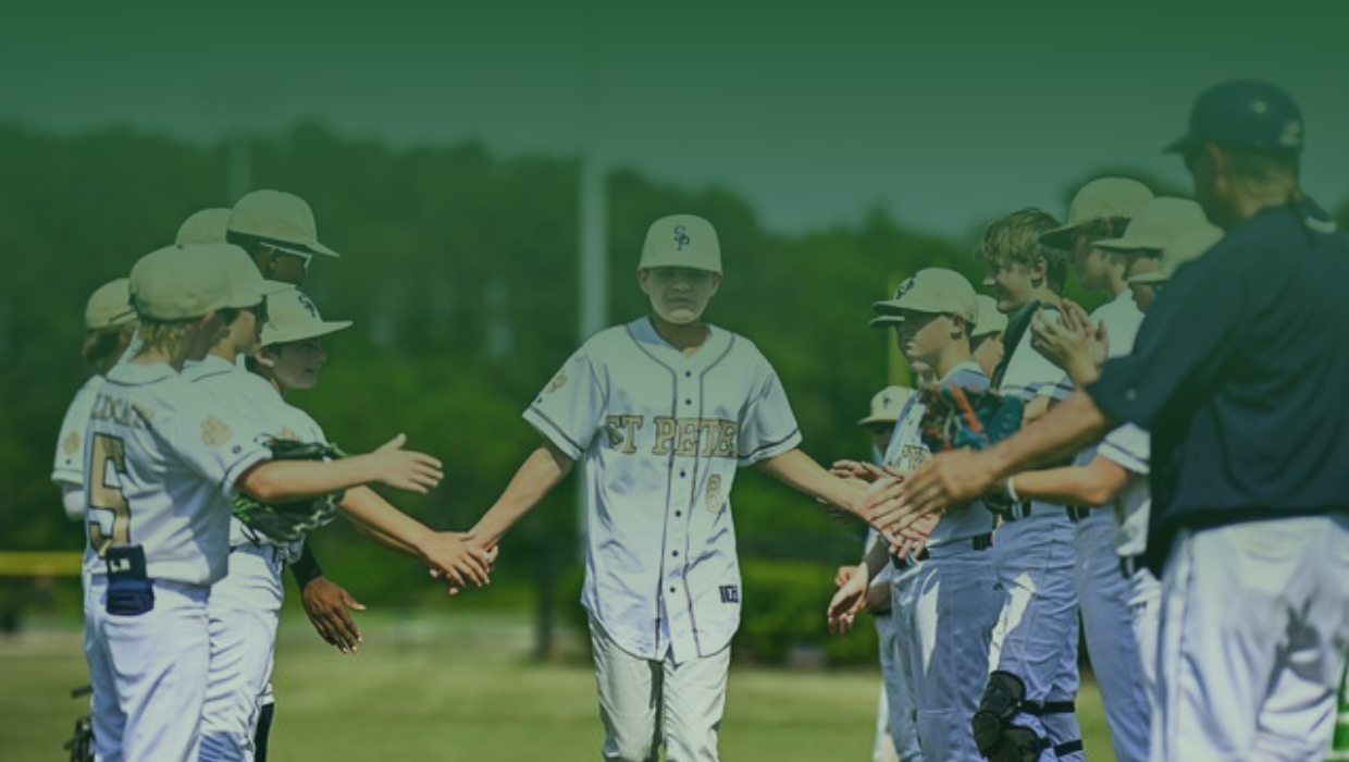 SPS home headers page boy’s baseball team student, high-fives his teammates as he walks past them on the field