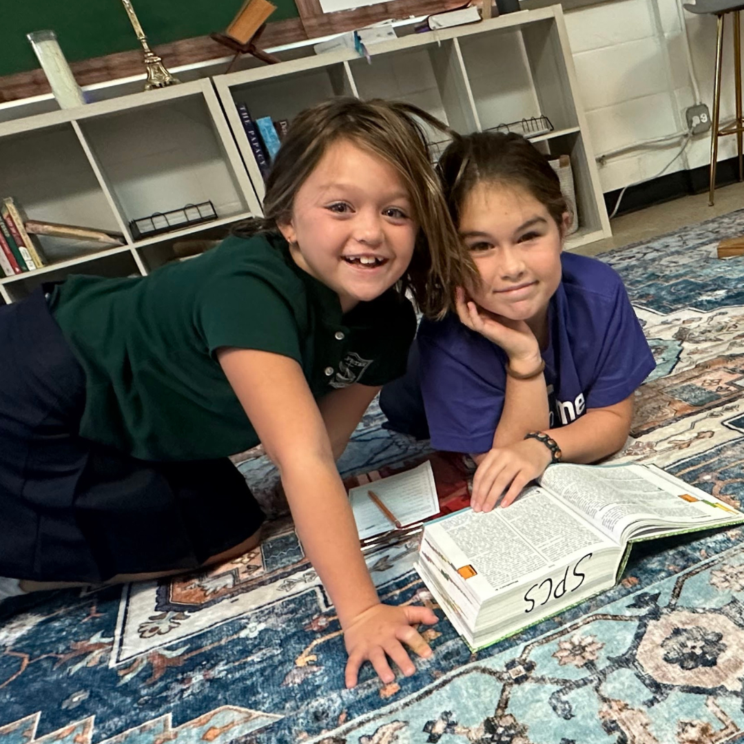 Students lay on the floor together reading the Bible