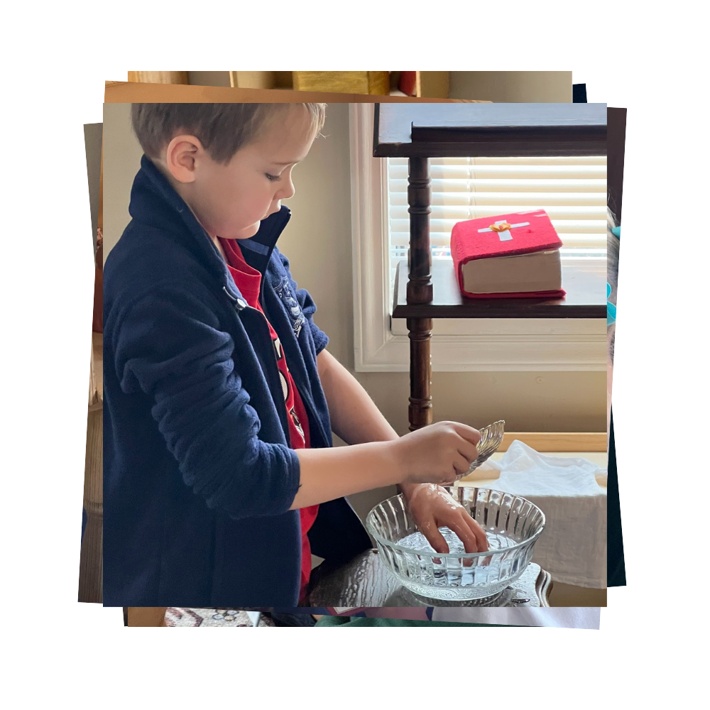 A boy pour water over his hand over a pretend baptism font