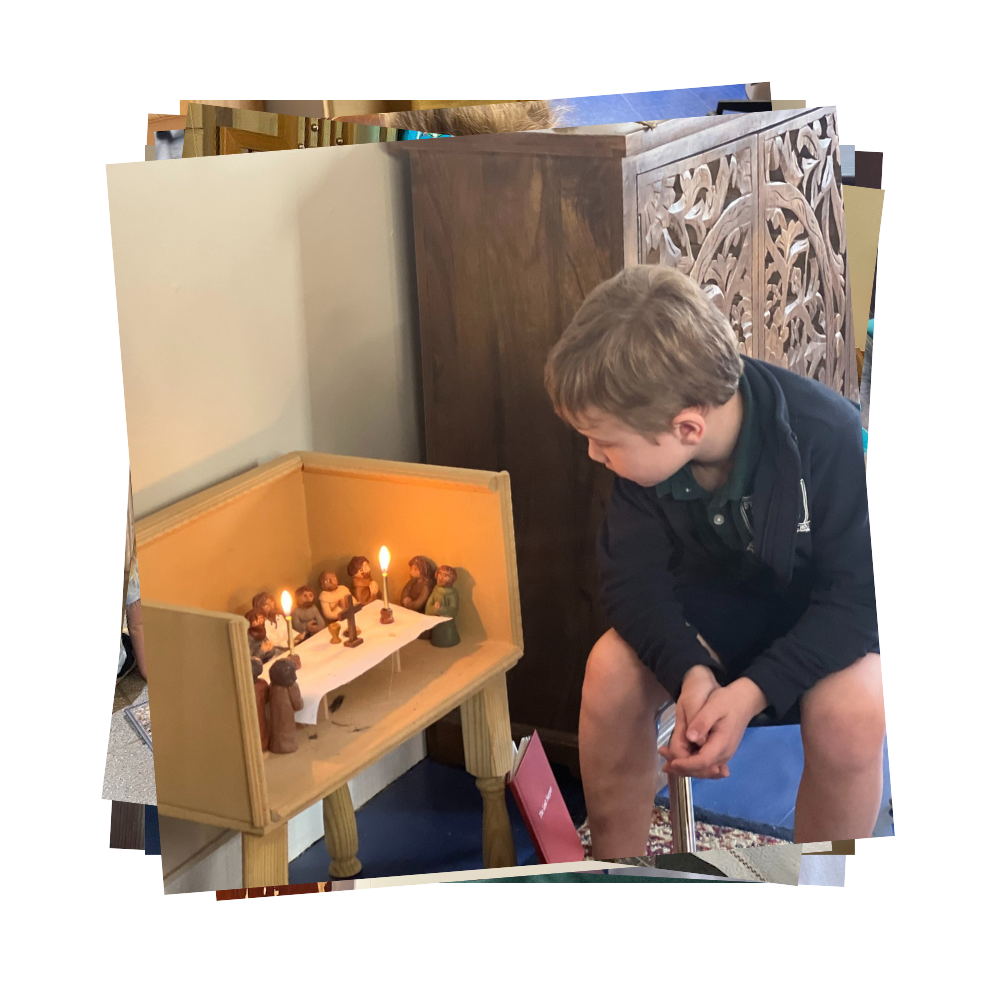 Boy sits looking at a display of Jesus and the apostles at the last supper