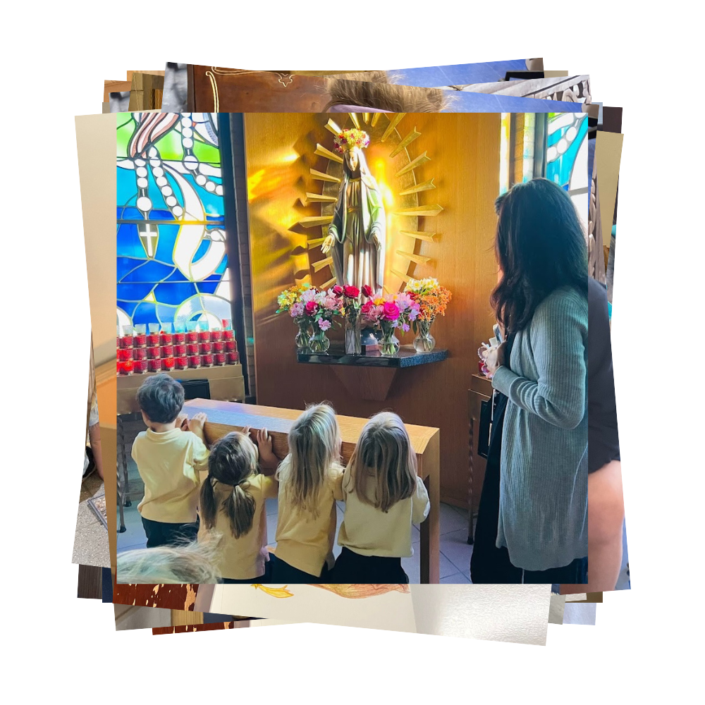 Young children kneel on kneeler in front of statue of Our Lady of Guadalupe
