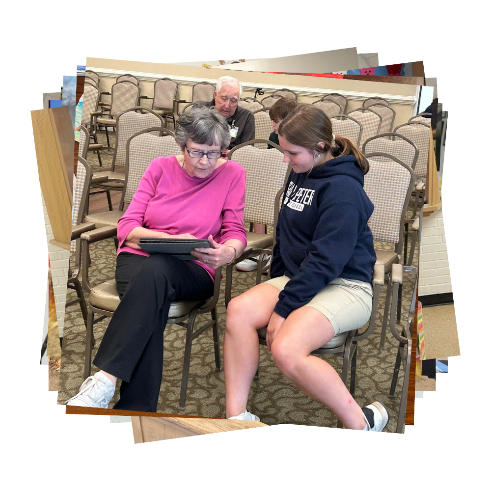 SPCS student helping elderly woman learn how to use her iPad