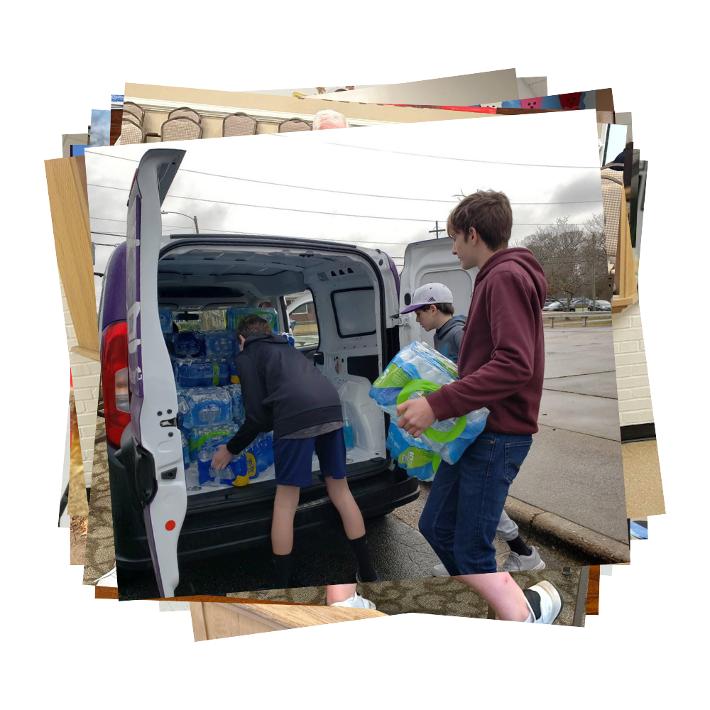 Students loading water bottles into the back of a truck