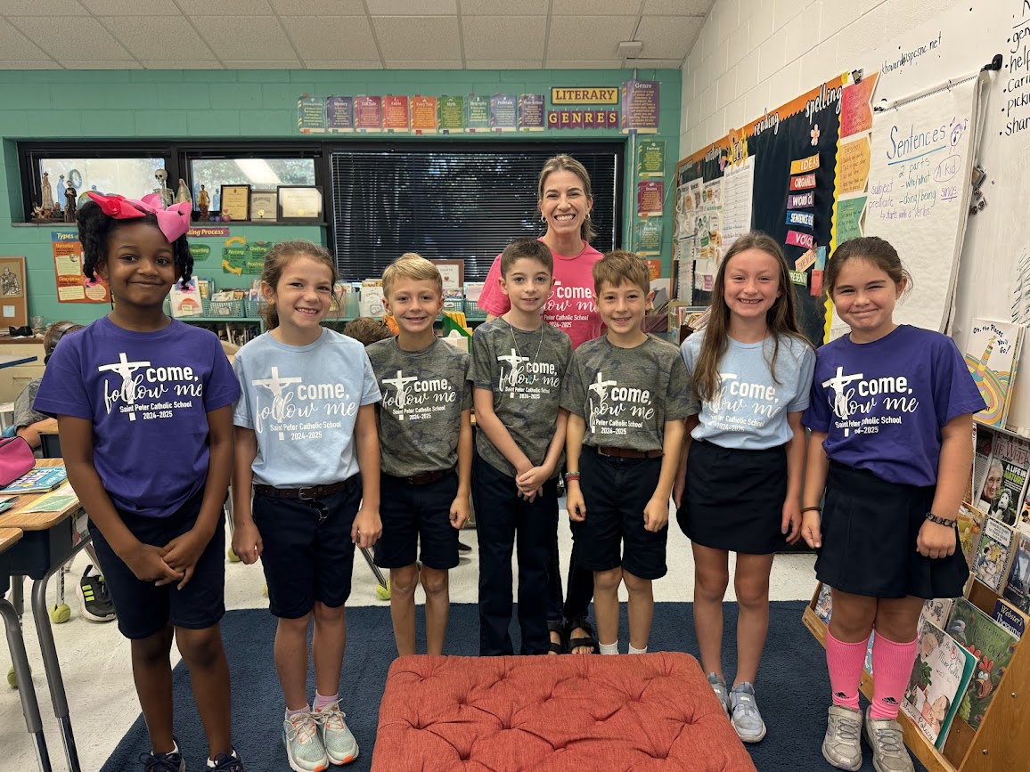 Fifth grade students in their classroom wearing school spirit shirts