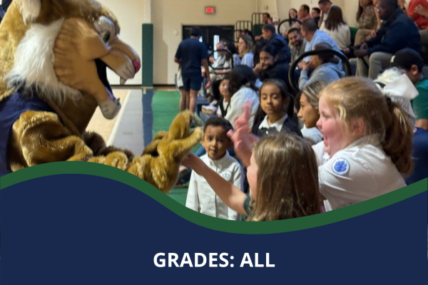 Students giving St. Peter Catholic School mascot a high five at a sporting event with a caption that reads "Grades: All"