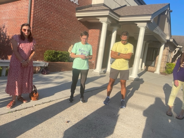 people praying in front of school