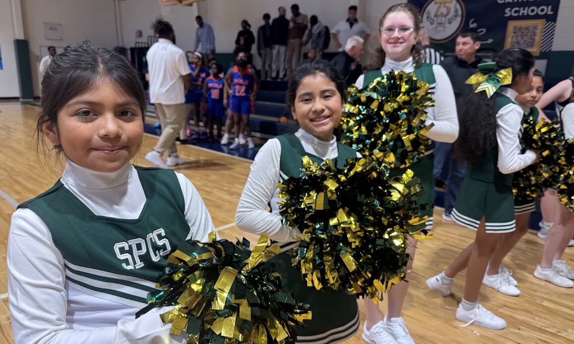 St. Peter Catholic School cheerleaders smiling at the camera