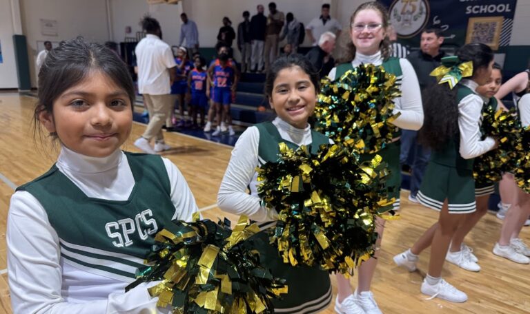 St. Peter Catholic School cheerleaders smiling at the camera