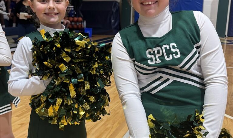 St. Peter Catholic School cheerleaders smiling at the camera