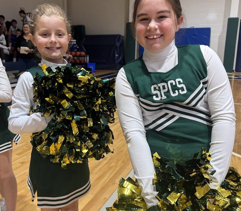 St. Peter Catholic School cheerleaders smiling at the camera